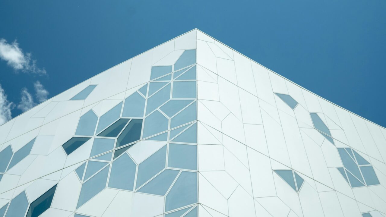 Geometric white facade of Edmonton Library against a blue sky